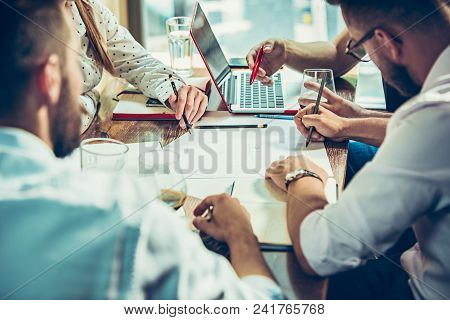 Young Cheerful People Smile And Gesture While Relaxing In Pub. Team Job. Photo Young And Mature Busi