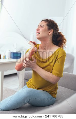 Soi Tchy. Adolescent Curly Lady Being Unable To Stop Scratching Herself While Suffering From A Terri