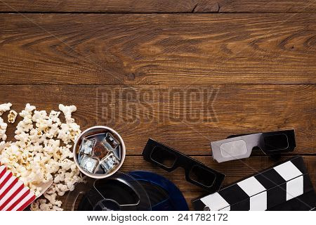 Cinema Background, Top View. Clapperboard, Popcorn, Soda And 3d Glasses On Wooden Table, Copy Space.