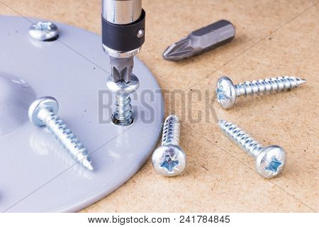 The Screwing Of The Screw With A Screwdriver.