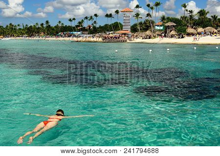 Relaxing Tourist Swimming On The Dominicus Beach On Dominican Republic. Coast Of The Del Este Nation