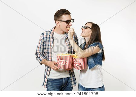 Young Happy Couple, Woman And Man In 3d Glasses Watching Movie Film On Date, Holding Buckets Of Popc