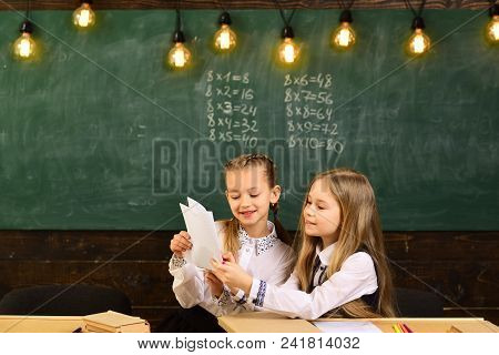 Attentive Schoolkid Is Doing His Math Homework In Classroom At School. Kids Need To Do Homework On R
