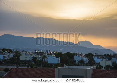 Dawn In Summer Over The City In The Mountains With Hanging Clouds On The Horizon At Sea. Turkey, Ala