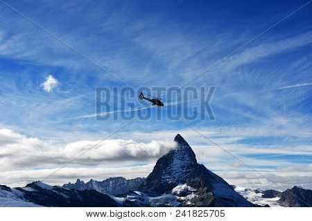 Escue Helicopter Over The Matterhorn Mountain In Switzerland