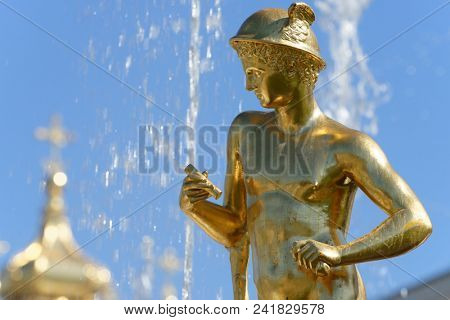 PETERHOF, ST. PETERSBURG, RUSSIA - MAY 10, 2018: Golden statues of the Grand Cascade. The cascade was built in 1715-1724 and is one of the remarkable fountain constructions in the world