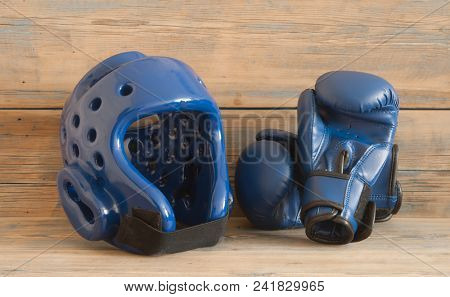set Taekwondo equipment on a wooden background stock photos. Sports, martial arts. Protective equipment for fight in full contact