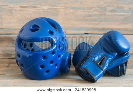 set Taekwondo equipment on a wooden background stock photos. Sports, martial arts. Protective equipment for fight in full contact