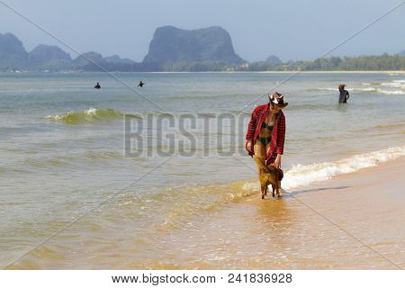 Woman Relax Outdoor With Dog And Hat On Beach At Bang Beot Beach, Chumphon Province Thailand