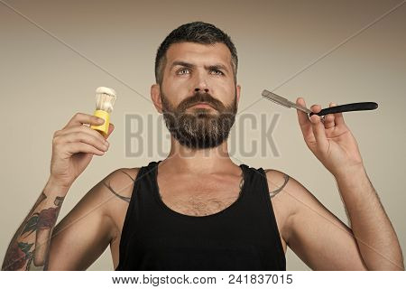 Man Face Handsome. Man Cut Beard And Mustache With Razor And Shaving Brush. Serious Hipster In Barbe
