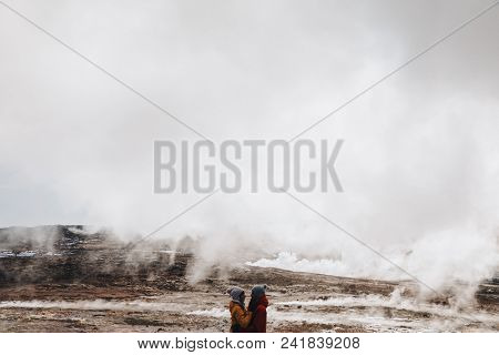 Beautiful Young Couple Embracing Near Majestic Hot Springs In Iceland, Reykjanes, Gunnuhver Hot Spri