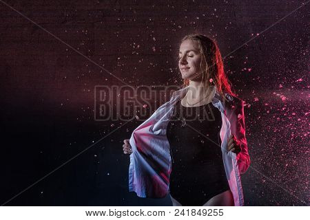 Portrain Of The Girl In The White Shirt With Water Drop In A Dark Room Illuminated By Light During A