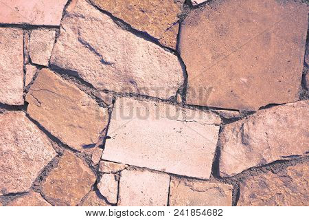 Cement Masonry Of Uneven Natural Stone, Textured Background.