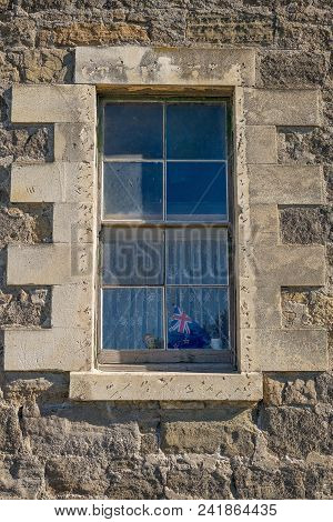 Old Window In A Deserted Building Showing Knick Knacks On The Sill, Framed By Rough Concrete Bricks