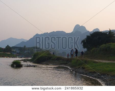 Sunset At Riverside With Mountain Background , Travel In Vang Viang City, Laos. 5Th December, 2013.