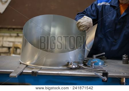 Manufacture Of Ventilation Pipes.the Worker Makes A Vent Pipe