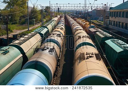 Railway Landscape With Many Old Railway Freight Cars On Rails On A Sunny Day Close Up.
