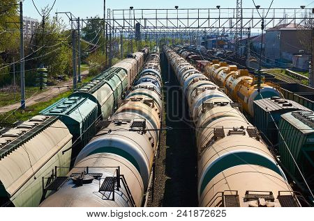 Railway Landscape With Many Old Railway Freight Cars On Rails On A Sunny Day Close Up.