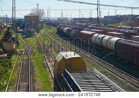 Railway Landscape With Many Old Railway Freight Cars On Rails On A Sunny Day Close Up.
