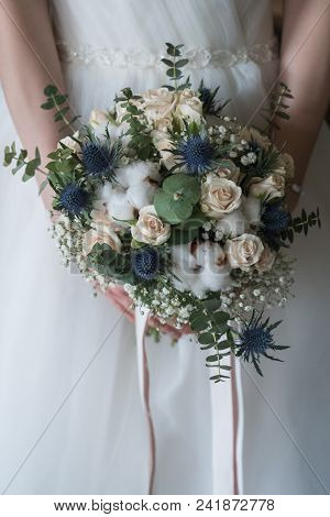 Young Bride Holds Spring Wedding Bouquet. Weddding Concept