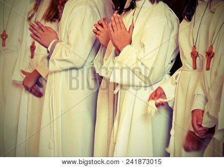 Children With Long White Tunic During The First Communion At Church  With Vintage Effect