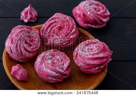 Close-up Homemade Meringues On Wooden Plate And Dark Background