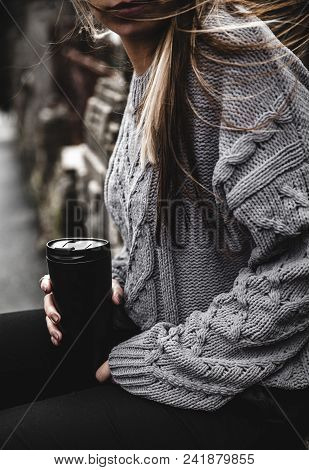 Young Beautiful Girl In A Warm Knitted Sweater And Boots Posing On The Street, On The Street Porttra
