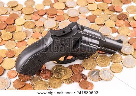 Picture Of A Business Money Concept Idea Coins And Gun