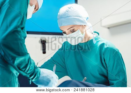 Team of surgeons in operation room during surgery from low angle view