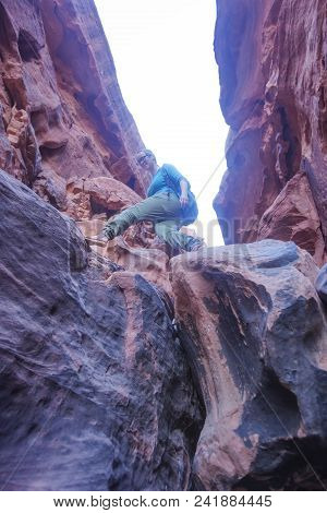 Girl-traveler Makes A Step In A Narrow Gorge