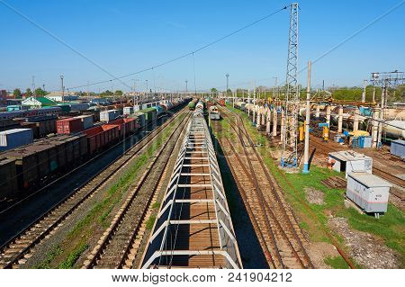 Railway Landscape With Many Old Railway Freight Cars On Rails On A Sunny Day Close Up.
