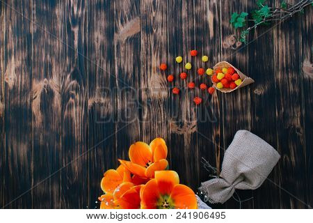 Tulips With Sweets In A Waffle Horn On A Wooden Background.