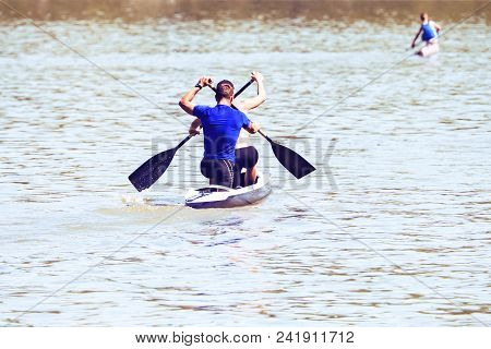 Pair Of Professional Sportsmen Swimming On Kayak At Competition, Cross Shape Oars