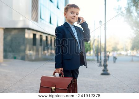 Concept Future Businessman. High Angle Of  Smiling Businessman In Formal Wear Standing On Pedestrian