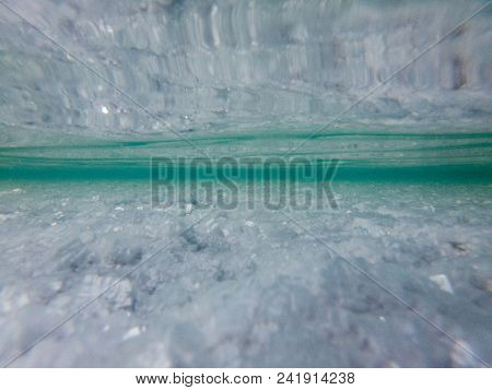 Underwater view of a salty lake which is located at Uyuni salt flat in Bolivia. Thin layer of water covers some parts of Uyuni salt flat. Image contains some artifacts.