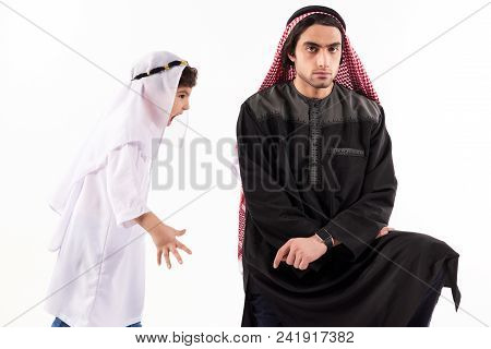Arab Boy Screams At Adult Father In Keffiyeh. Isolated On White Background. Parenthood Concept.