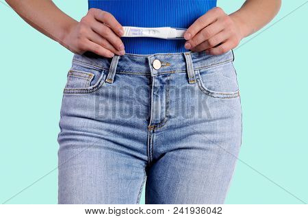 Pregnant Test. Woman Holdinj A Positive Pregnancy Test