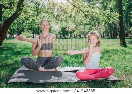 A Picture Of Woman Is Sitting On The Back With Her Daughter Sitting In The Front. They Are Sitting I