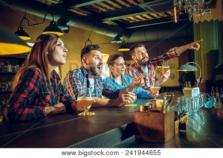 Sport, People, Leisure, Friendship, Entertainment Concept - Happy Male And Female Football Fans Or G