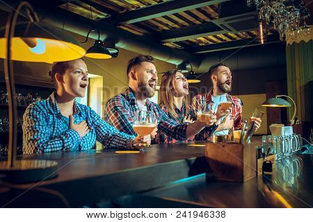 Sport, People, Leisure, Friendship, Entertainment Concept - Happy Male And Female Football Fans Or G