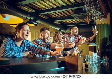 Sport, People, Leisure, Friendship, Entertainment Concept - Happy Male And Female Football Fans Or G