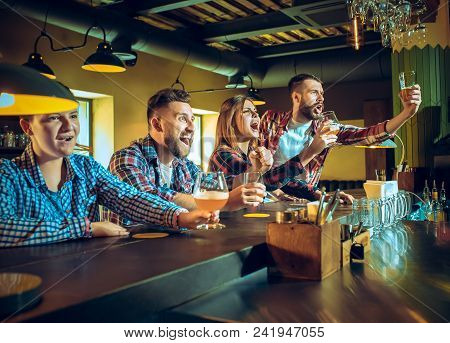 Sport, People, Leisure, Friendship, Entertainment Concept - Happy Male And Female Football Fans Or G