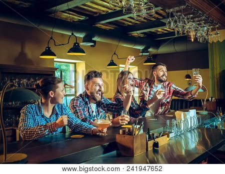 Sport, People, Leisure, Friendship, Entertainment Concept - Happy Male And Female Football Fans Or G