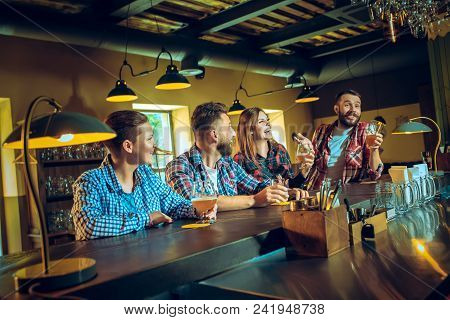 Sport, People, Leisure, Friendship, Entertainment Concept - Happy Male And Female Football Fans Or G