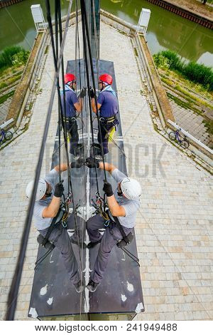 Industrial Climbers Are Applying Silicone On Joints Between Windows