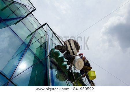 Industrial Climbers Are Applying Silicone On Joints Between Windows