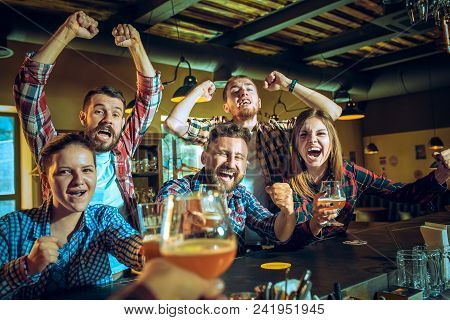 Sport, People, Leisure, Friendship, Entertainment Concept - Happy Male And Female Football Fans Or G