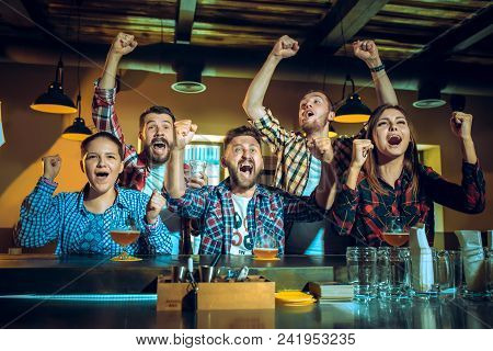 Sport, People, Leisure, Friendship, Entertainment Concept - Happy Male And Female Football Fans Or G