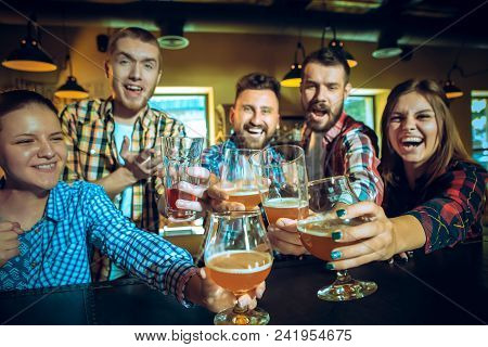 Sport, People, Leisure, Friendship, Entertainment Concept - Happy Male And Female Football Fans Or G
