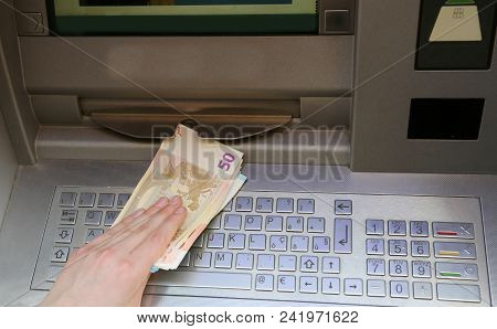 Hand That Withdraws Money Euro Banknotes From An Atm Machine Of A Bank